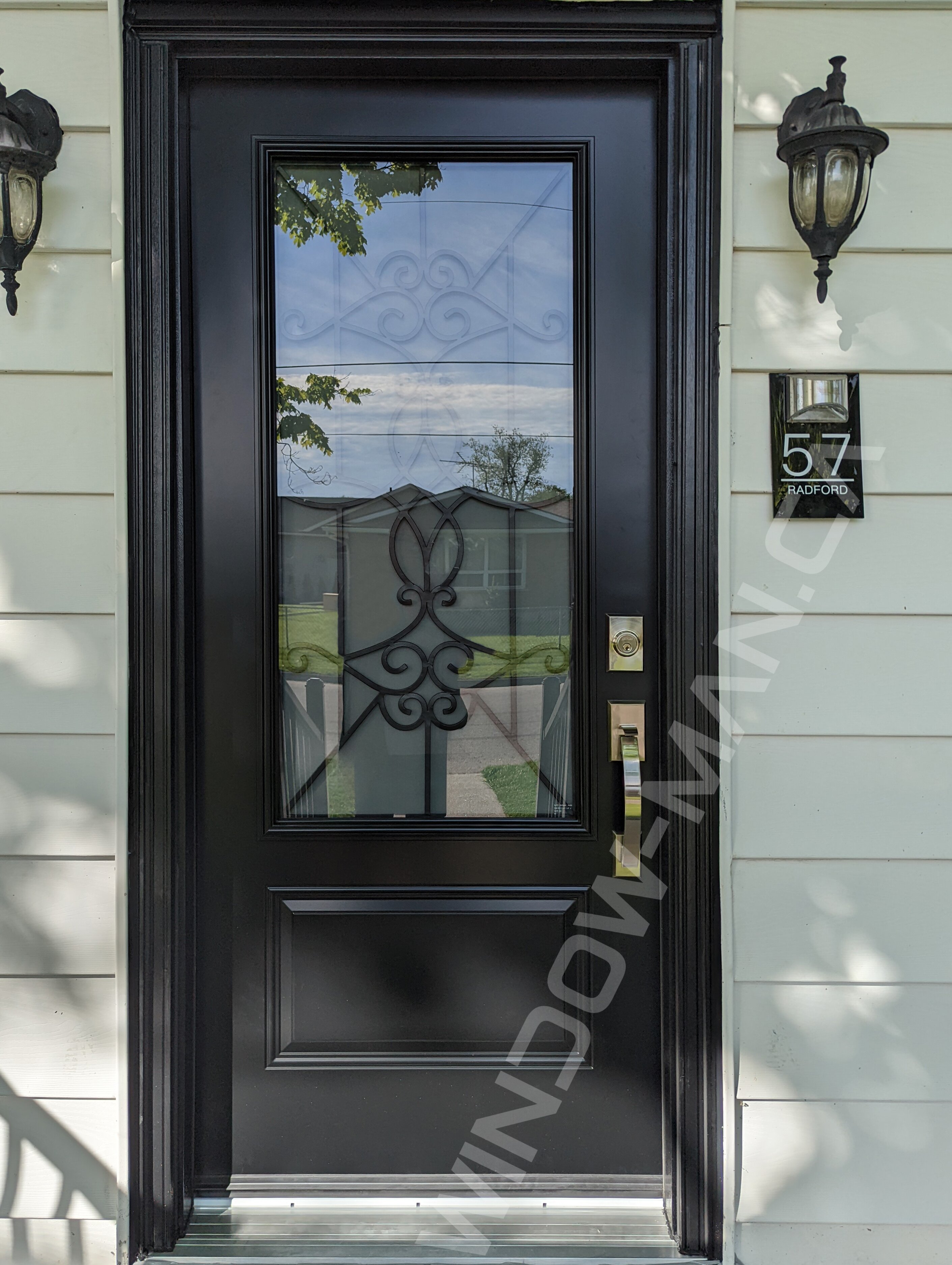 black steel door with 3/4 blackburn wrought iron glass and storm door