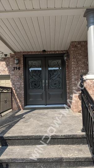 grey doors double in windswept smoke with port union 3/4 wrought iron glass executive panels - view from the outside